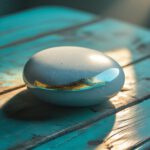 cracked stone with golden fracture on wooden surface